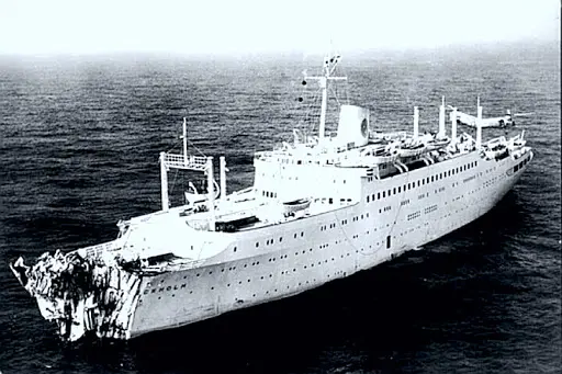 A large white ship in the ocean with waves.