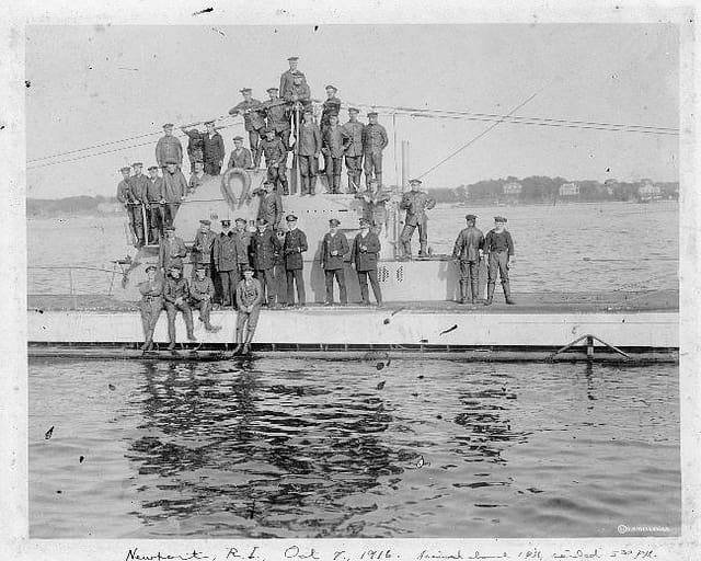 A group of men standing on top of a boat.