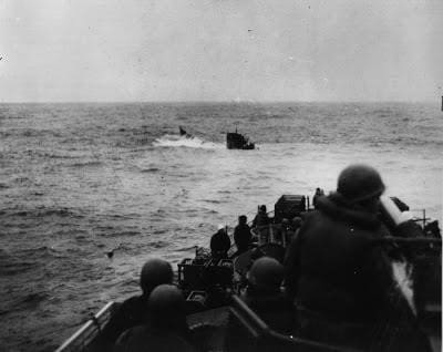 A group of men on boats in the ocean.