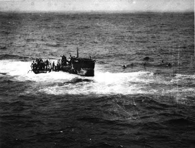 A boat with people on it in the ocean.