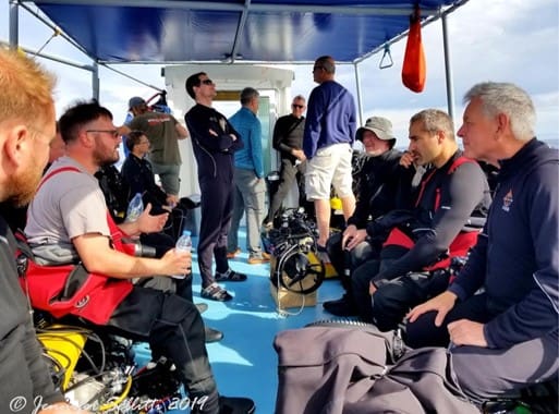 A group of people on the deck of a boat.