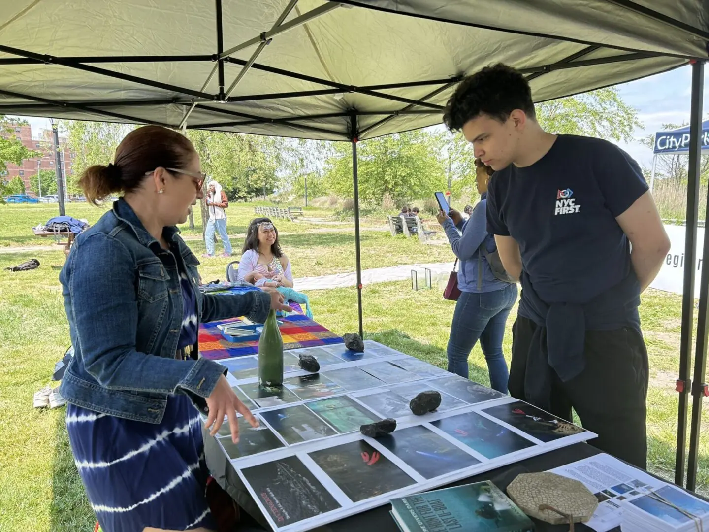 A man and woman looking at photos on display.