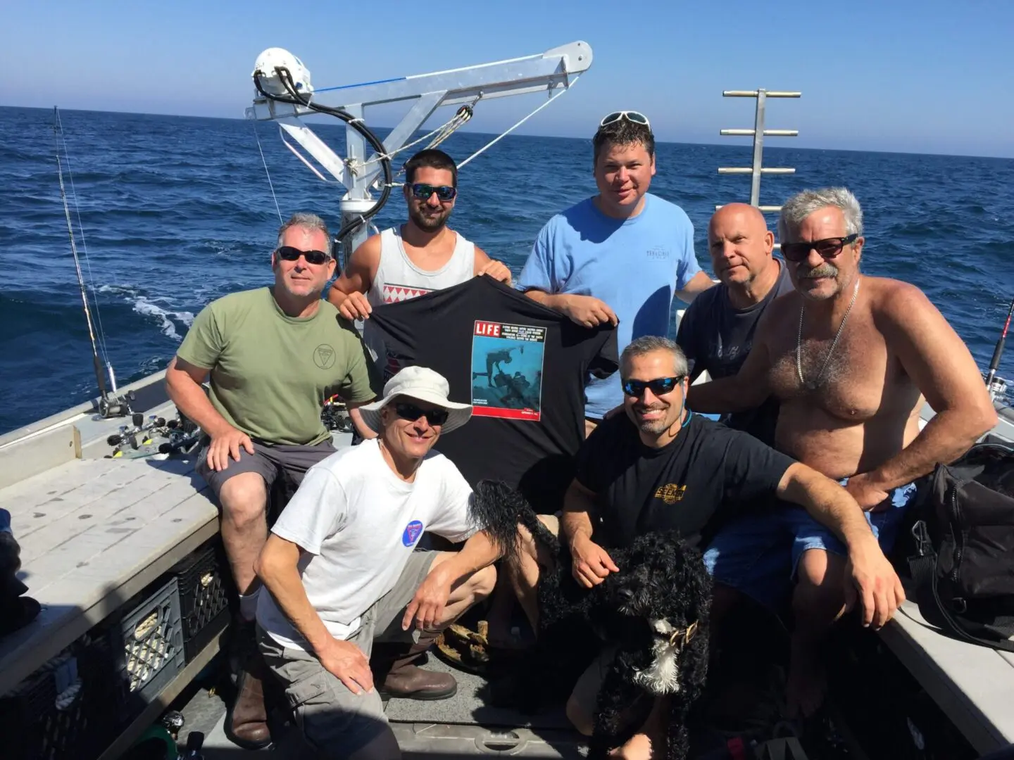 A group of people on a boat with a dog.