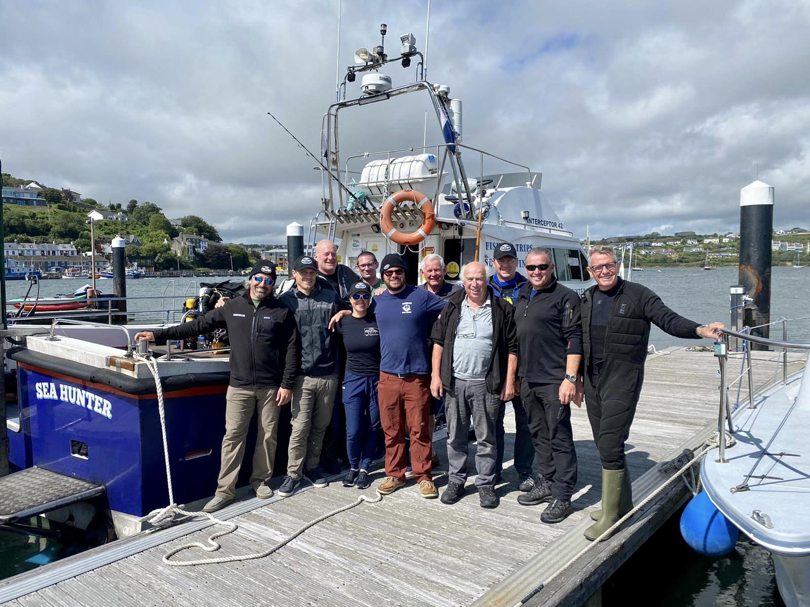 Divers and surface support crew celebrate a successful expedition. Photo © D/V Tenacious 2021.
