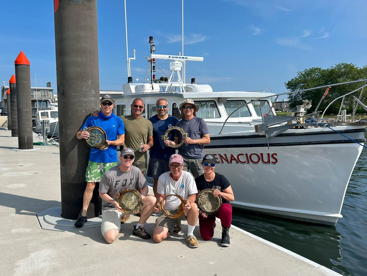 The 2024 discovery team. (Back left to right) Andrew Donn, Kurt Mintell, Joe Mazraani, and Tom Packer. (Front left to right) Tim Whitehead, Eric Takakjian, and Jennifer Sellitti. © Atlantic Wreck Salvage 2024