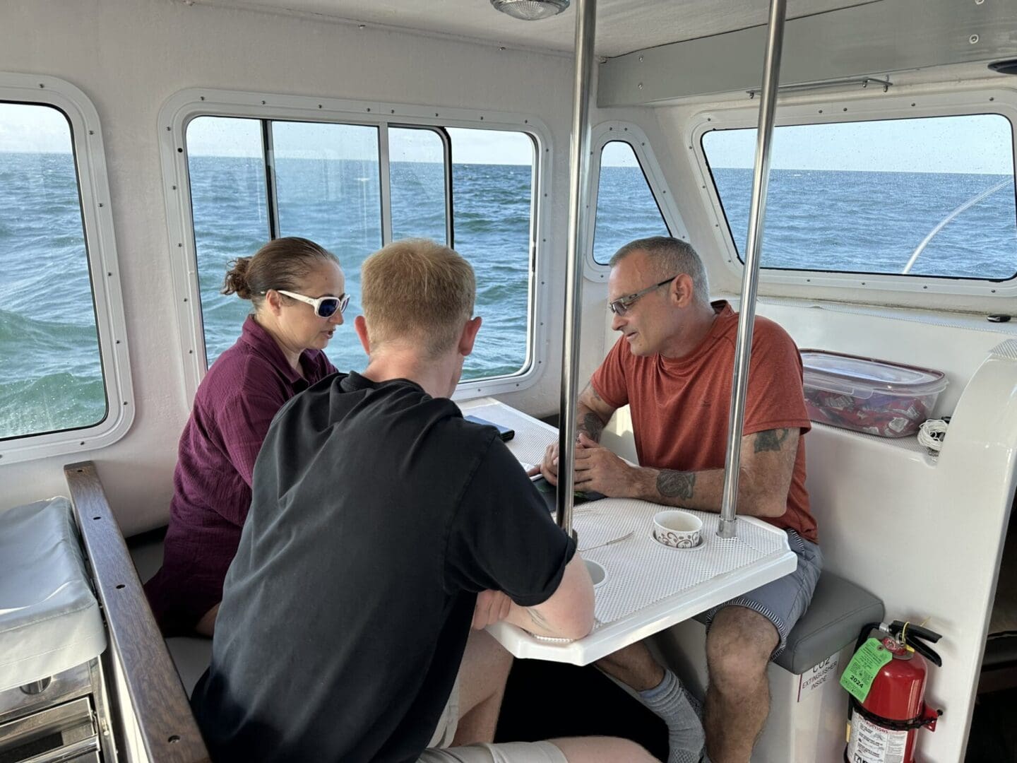 Jennifer Sellitti, Tim Whitehead (center), and Kurt Mintell review historical documents in preparation for the team's dives. © Atlantic Wreck Salvage 2024