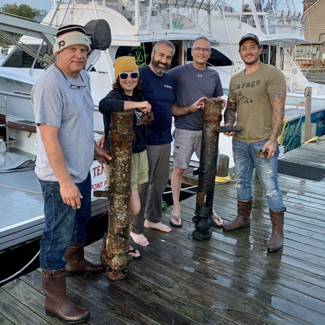 A group of people standing on top of a dock.